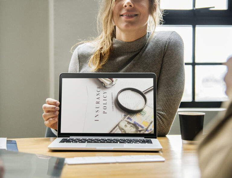 Woman presenting laptop with photo of life insurance policy